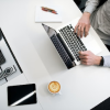 Stock photo sample of someone using a laptop at an office desk